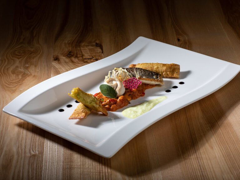 Wellenförmiger Teller mit Calamari und Frühlingsrollen im 4-Sterne-Hotel Hüttenhof